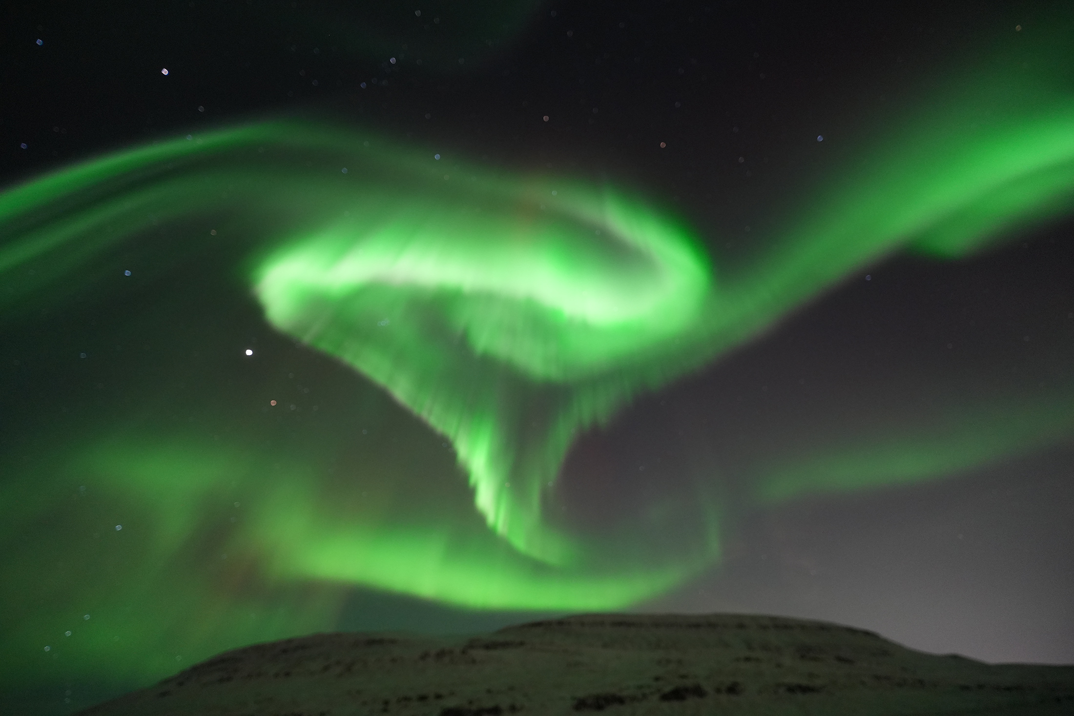 Dancing Nothern Lights in the sky outside Reykjavik Iceland. Northern lights small group tours in Iceland. Departure from Reykjavík.